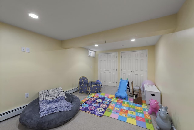 playroom featuring carpet and a baseboard heating unit