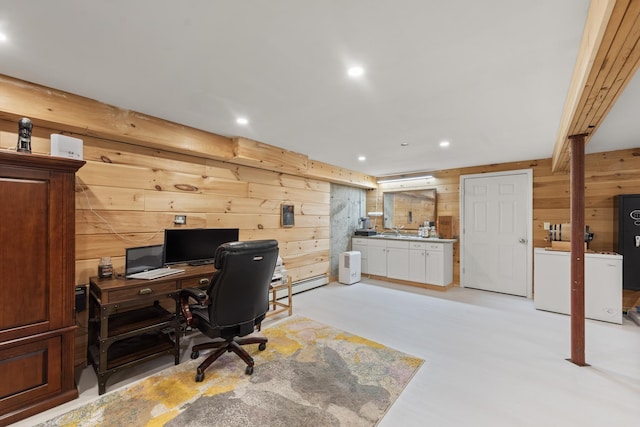 office featuring wooden walls, sink, and a baseboard heating unit