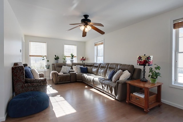 living room featuring dark hardwood / wood-style floors and ceiling fan