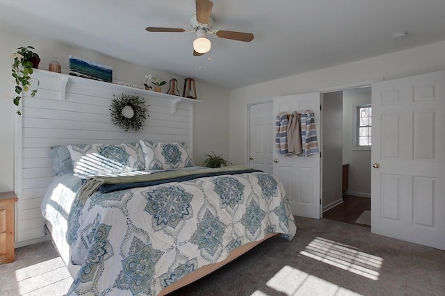 carpeted bedroom with ceiling fan and a closet