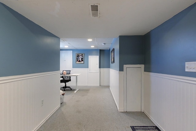 hallway with light colored carpet