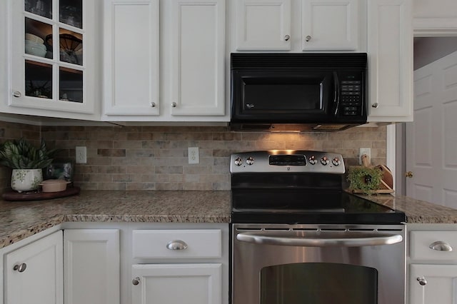 kitchen with tasteful backsplash, stainless steel electric range oven, light stone counters, and white cabinetry