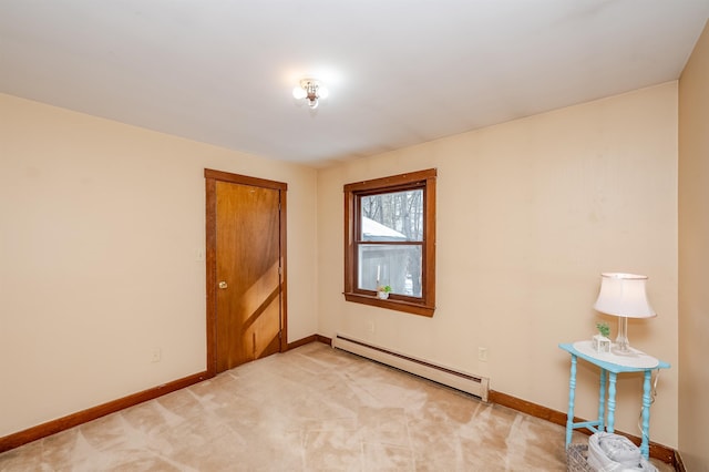 carpeted spare room featuring a baseboard radiator