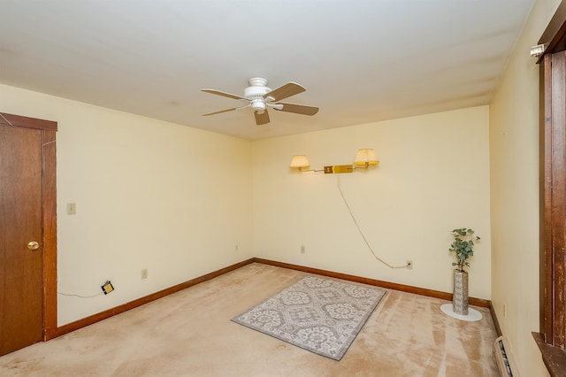 carpeted empty room featuring ceiling fan and baseboard heating