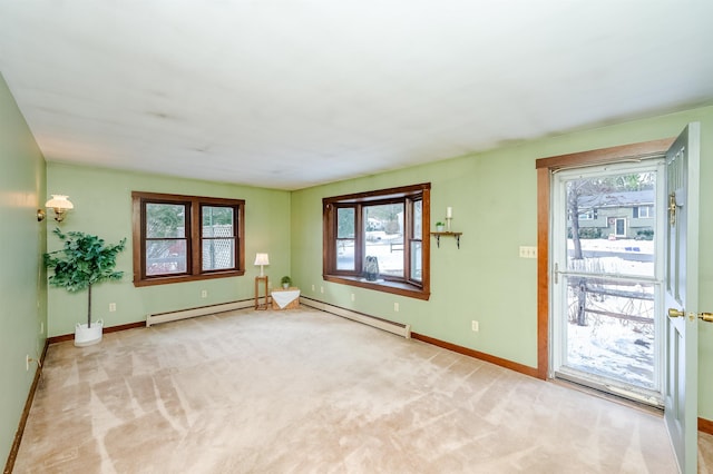 interior space featuring a baseboard heating unit and a healthy amount of sunlight