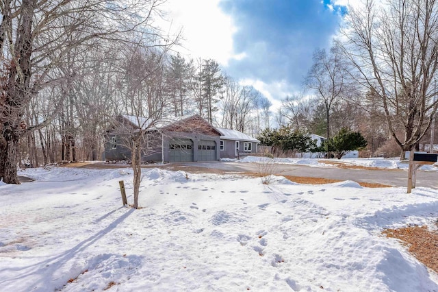 yard layered in snow featuring a garage