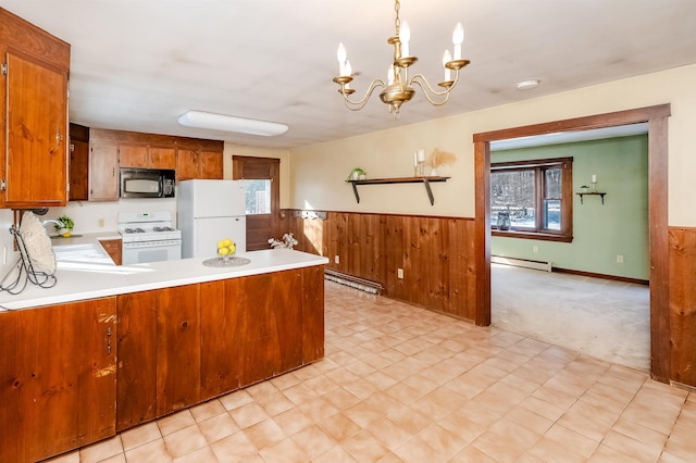 kitchen featuring pendant lighting, kitchen peninsula, white appliances, and baseboard heating