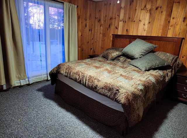 carpeted bedroom with wood walls