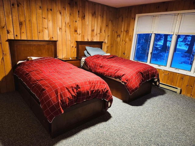 bedroom with a baseboard heating unit, carpet flooring, and wooden walls