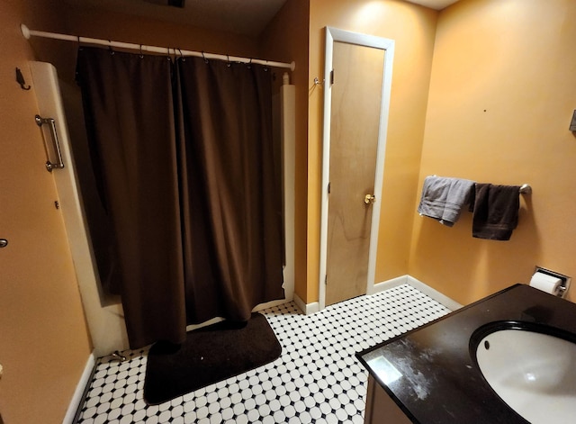 bathroom featuring sink and a shower with shower curtain