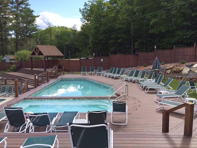 view of swimming pool with a wooden deck and a gazebo