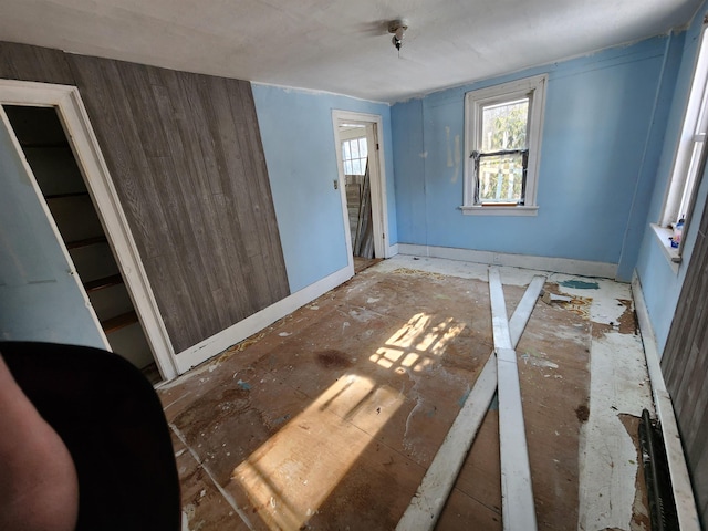 unfurnished bedroom with wood walls