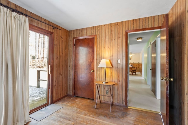 entryway with wood-type flooring and wood walls