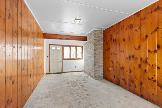 unfurnished room with wooden walls