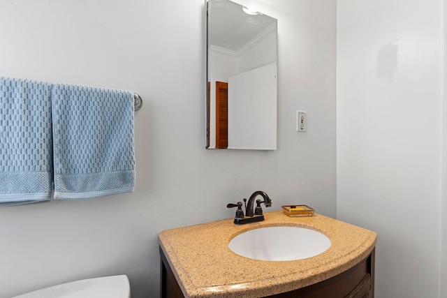 bathroom featuring ornamental molding and vanity