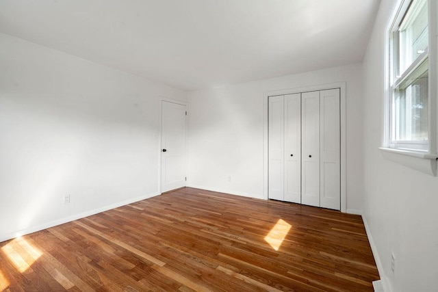 50 Suzanne Dr, Portsmouth, NH 03801 - unfurnished bedroom featuring wood finished floors, a closet, and baseboards
