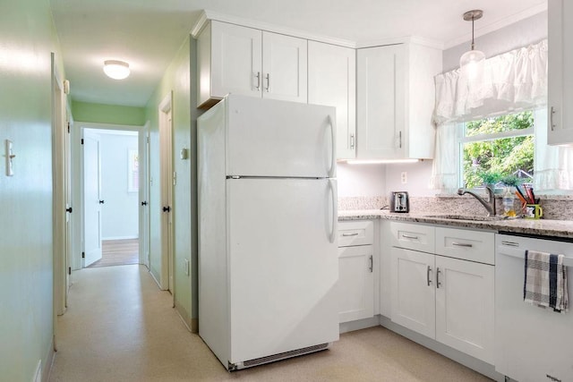 50 Suzanne Dr, Portsmouth, NH 03801 - kitchen with white appliances, a sink, white cabinets, light stone countertops, and hanging light fixtures