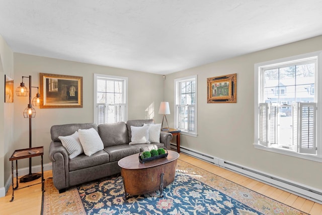 living room with a baseboard radiator and light hardwood / wood-style floors