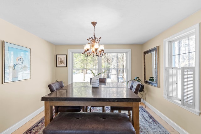 dining space with an inviting chandelier and hardwood / wood-style floors