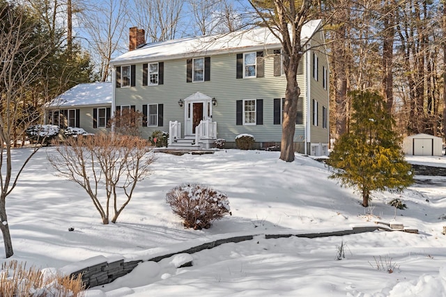 colonial house with a storage shed