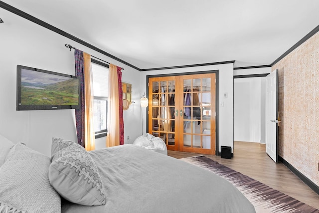 bedroom featuring crown molding, wood-type flooring, and french doors