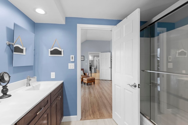 bathroom featuring a shower with door, vanity, and hardwood / wood-style floors