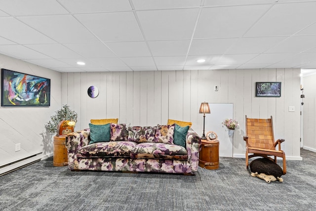 living room with a baseboard radiator, carpet flooring, and a drop ceiling