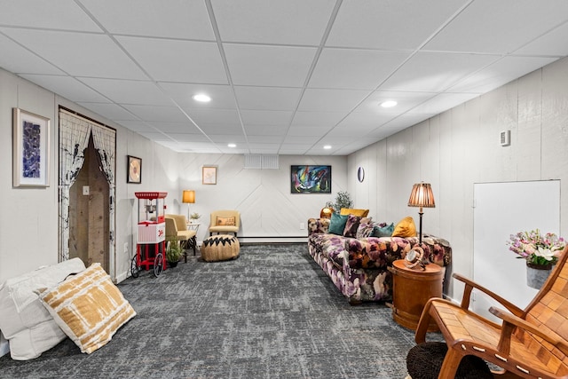 living room with dark colored carpet and a baseboard heating unit