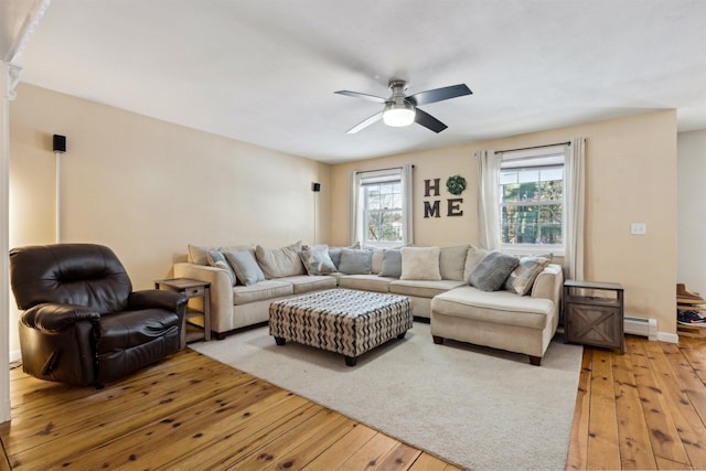 living room with a baseboard radiator, ceiling fan, and light hardwood / wood-style flooring