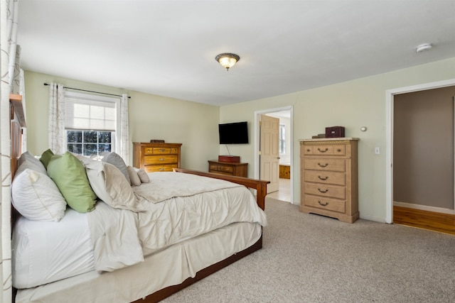 carpeted bedroom featuring connected bathroom