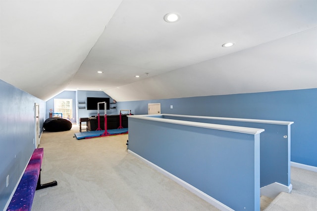 interior space featuring lofted ceiling and light colored carpet