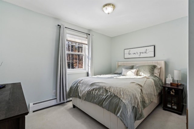 bedroom with light carpet and a baseboard heating unit