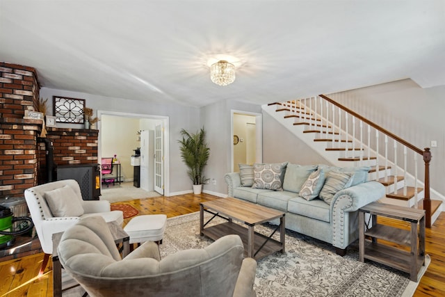 living room with hardwood / wood-style floors and a wood stove