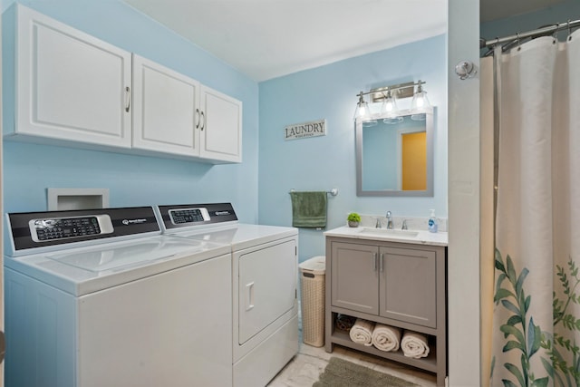 clothes washing area with cabinets, sink, and independent washer and dryer