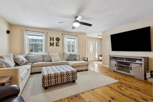 living room with light hardwood / wood-style floors and ceiling fan