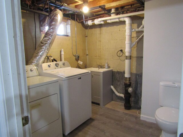 laundry area with wood-type flooring and independent washer and dryer