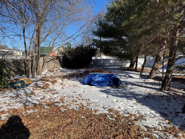 snowy yard featuring a pool