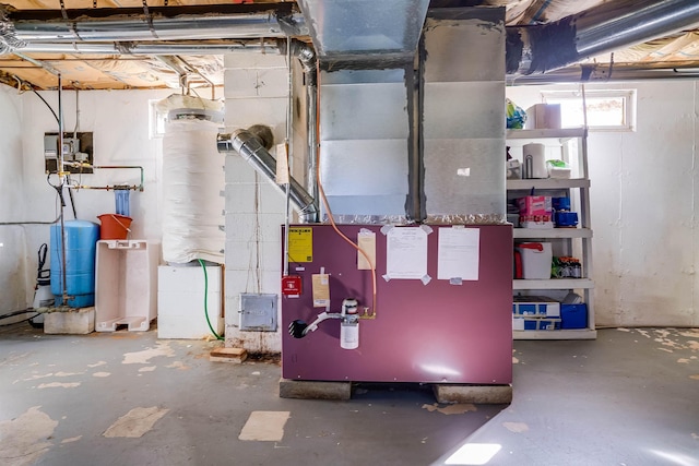 utility room featuring heating unit