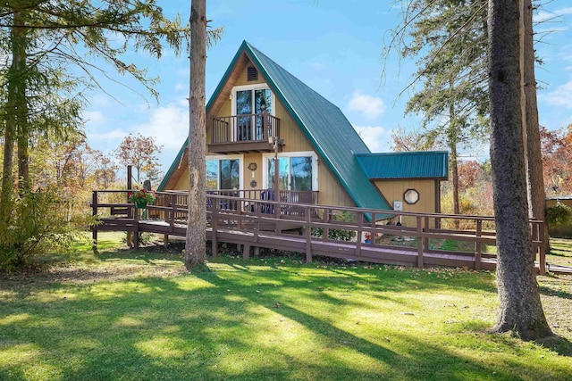 back of property with a balcony and a lawn