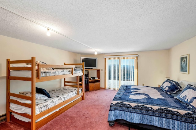 bedroom featuring a textured ceiling and carpet