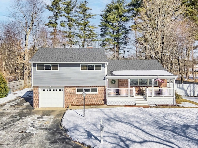 split level home with a garage and a porch