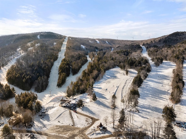 snowy aerial view featuring a mountain view