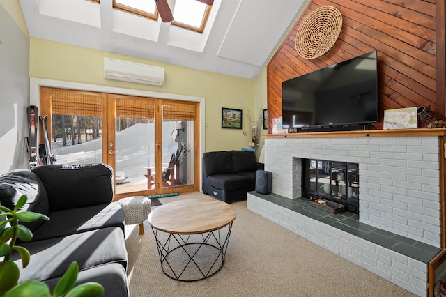 living room with vaulted ceiling with skylight, carpet, a wall mounted air conditioner, a fireplace, and wood walls