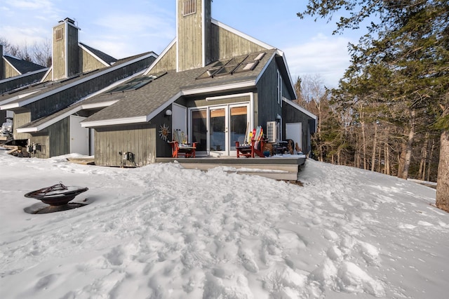 view of snow covered back of property