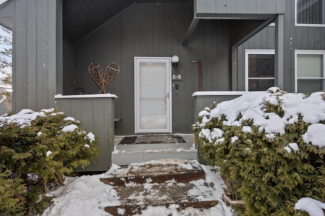 view of snow covered property entrance