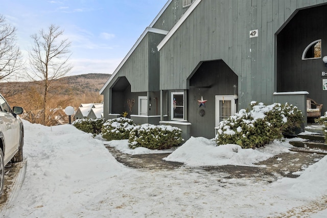 view of snow covered exterior featuring a mountain view