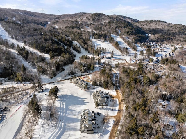 snowy aerial view with a mountain view