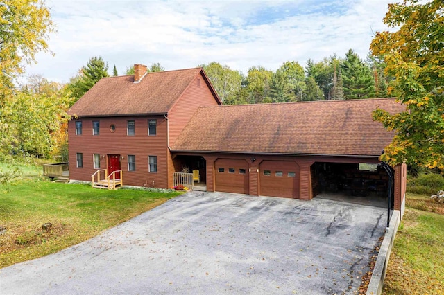 view of front of property with a garage and a front lawn