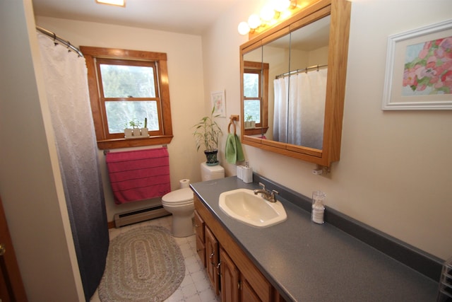 bathroom featuring baseboard heating, vanity, and toilet