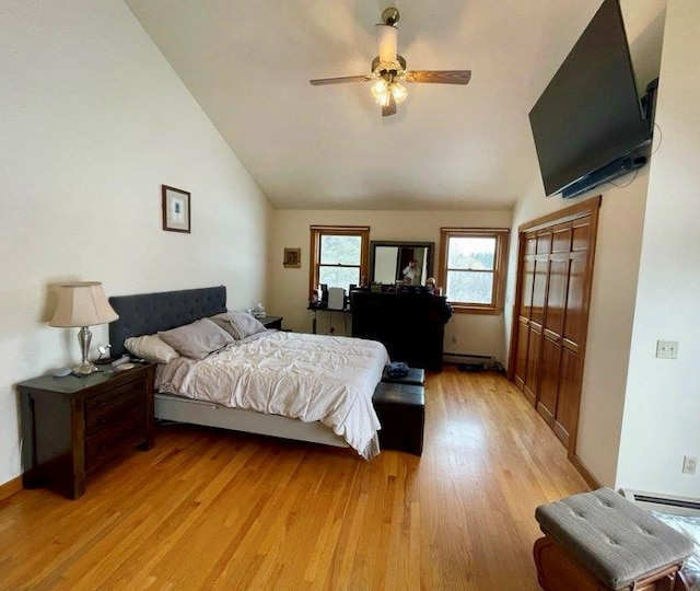 bedroom with lofted ceiling, ceiling fan, and light wood-type flooring